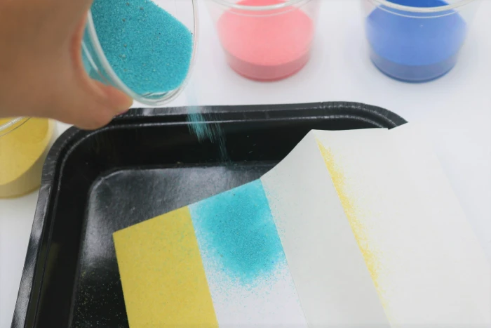 It's easy to create beautiful sand art with adhesive boards.